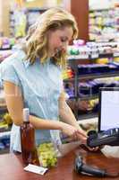 Woman at cash register paying with credit card