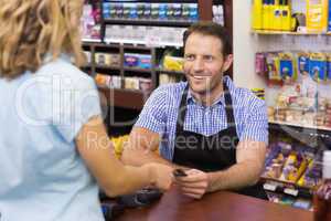 Woman at cash register paying with credit card