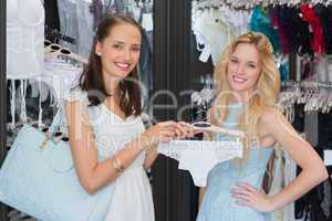 Happy women smiling at camera and showing underwear