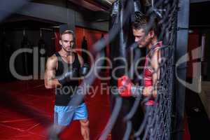 Boxing men training on a pushing ball