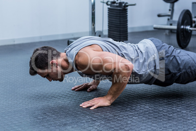 A muscular man doing a pushups