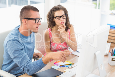 Concentrated coworkers using laptop and digitizer