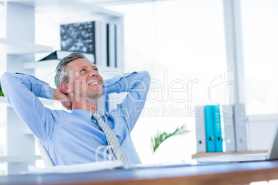 Businessman relaxing in swivel chair