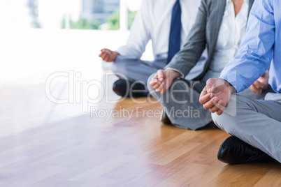 Close up view of business people doing yoga