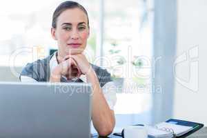 Thoughtful businesswoman looking at camera