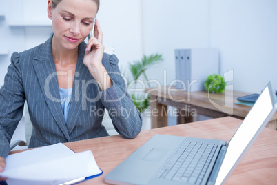 Pretty blonde businesswoman phoning