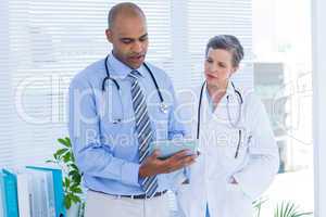 Medical colleagues working with tablet computer