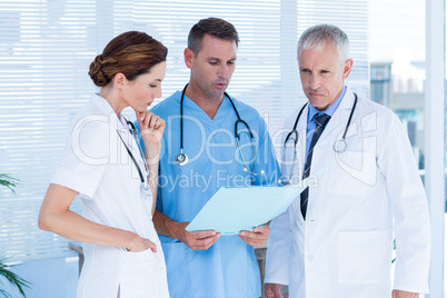 Concentrated medical colleagues analyzing file together