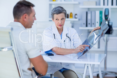 Doctor showing X rays to her patient