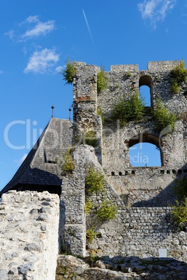 Contrail of the jet plane above ruin of Celje medieval castle in Slovenia