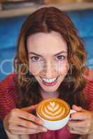 Casual brunette drinking coffee