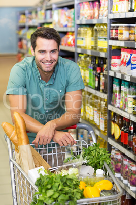 Portrait of smiling man buy product with his trolley