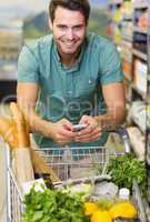 Portrait of smiling man buy a food and using his smartphone