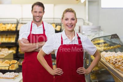 Portrait of two bakers with hands on hips