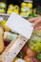 Woman writing in her notepad in aisle