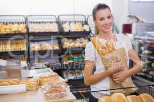 A pretty blonde woman buying bread