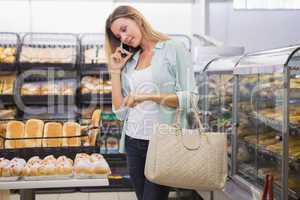 A woman buying bread in the pastries shelf