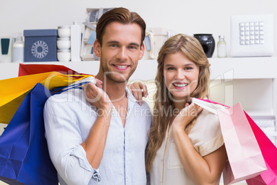 Portrait of a happy smiling couple with bags