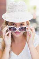 Pretty woman tilting her sunglasses