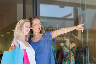 Smiling girls friends finger pointing