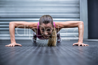 Muscular woman doing push ups