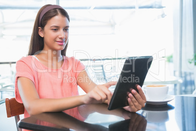 Young happy woman holding a tablet