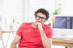 Handsome businessman sitting on a swivel chair and using his la