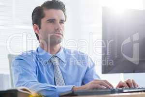 Serious businessman using computer