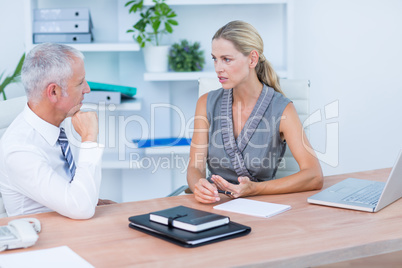 Colleagues speaking and working Colleagues speaking and working
