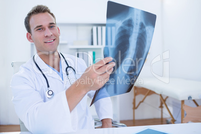 Serious doctor looking at Xray