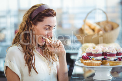 Astonished pretty woman looking at cakes