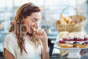 Astonished pretty woman looking at cakes