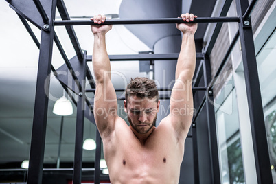Muscular man doing pull ups