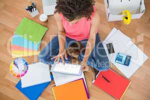 Young creative businesswoman scrolling on tablet