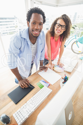 Two creative business colleagues looking at the camera