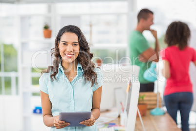 Smiling young woman using digital tablet