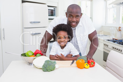 Little boy cooking with his father