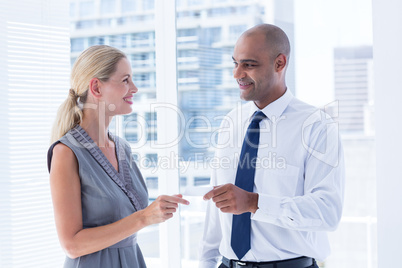 Businessman giving small paper sheet to his colleague