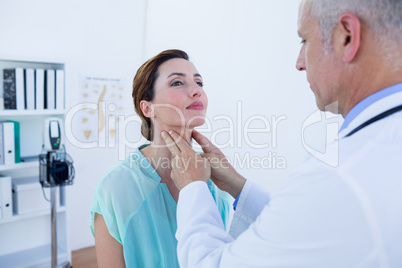 Doctor examining his patient neck