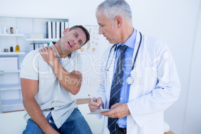 Doctor looking at patient shoulder