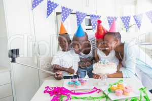 Happy family celebrating a birthday together and taking a selfie