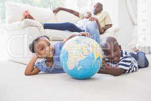 Happy siblings using their globe