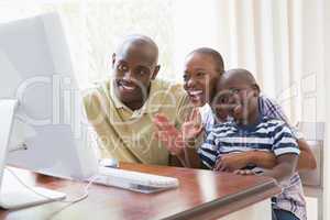 Happy smiling family chattting with computer