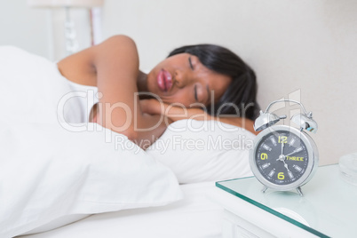 Pretty brunette sleeping in her bed