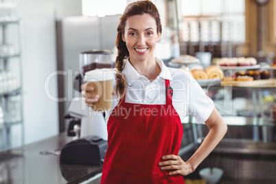 Pretty barista giving take-away cup