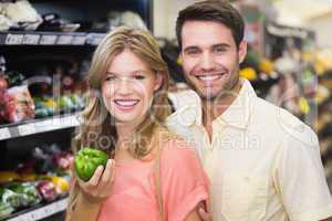 Portrait of smiling bright couple buying food products