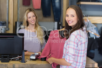 Pretty brunette doing shopping and smiling at camera