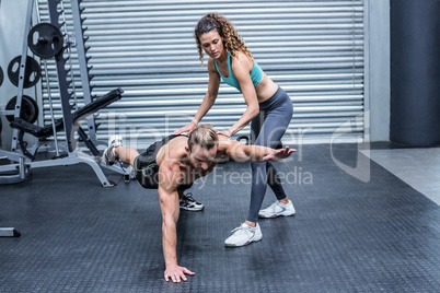 Muscular couple doing abdominal exercises