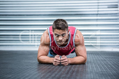 Portrait of muscular man in plank position