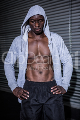 Young Bodybuilder in a hoodie looking worriedly to the ground